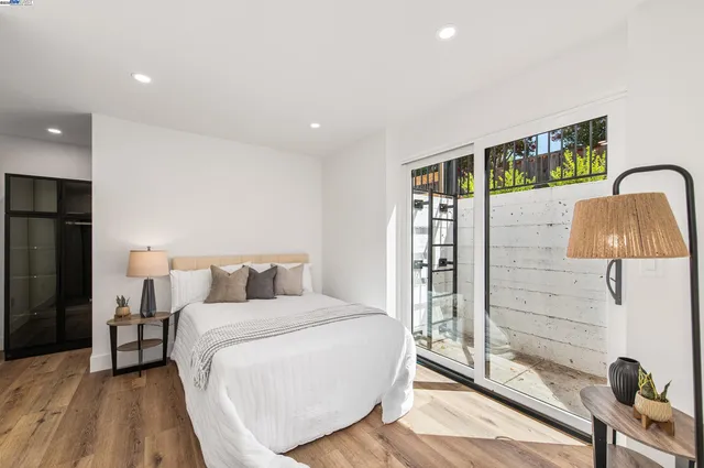 a bedroom with a bed and a large window