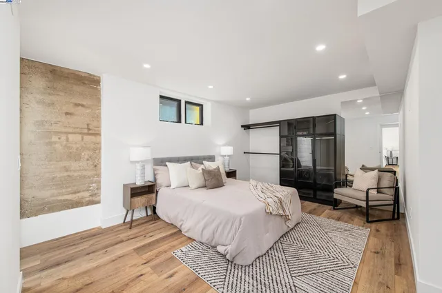 a bedroom with a bed and wooden floor