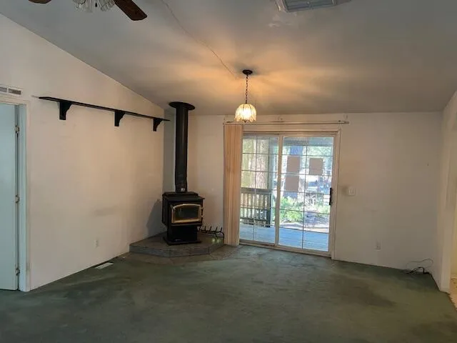 en empty room with windows and chandelier