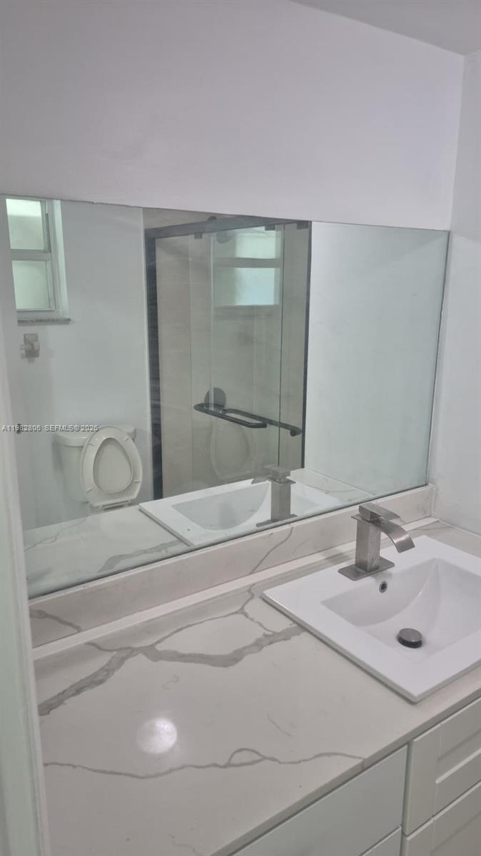 3355 West 68th Street, Unit 119 Hialeah, FL 33018 - Photo 9 of 11 a bathroom with a sink and a mirror