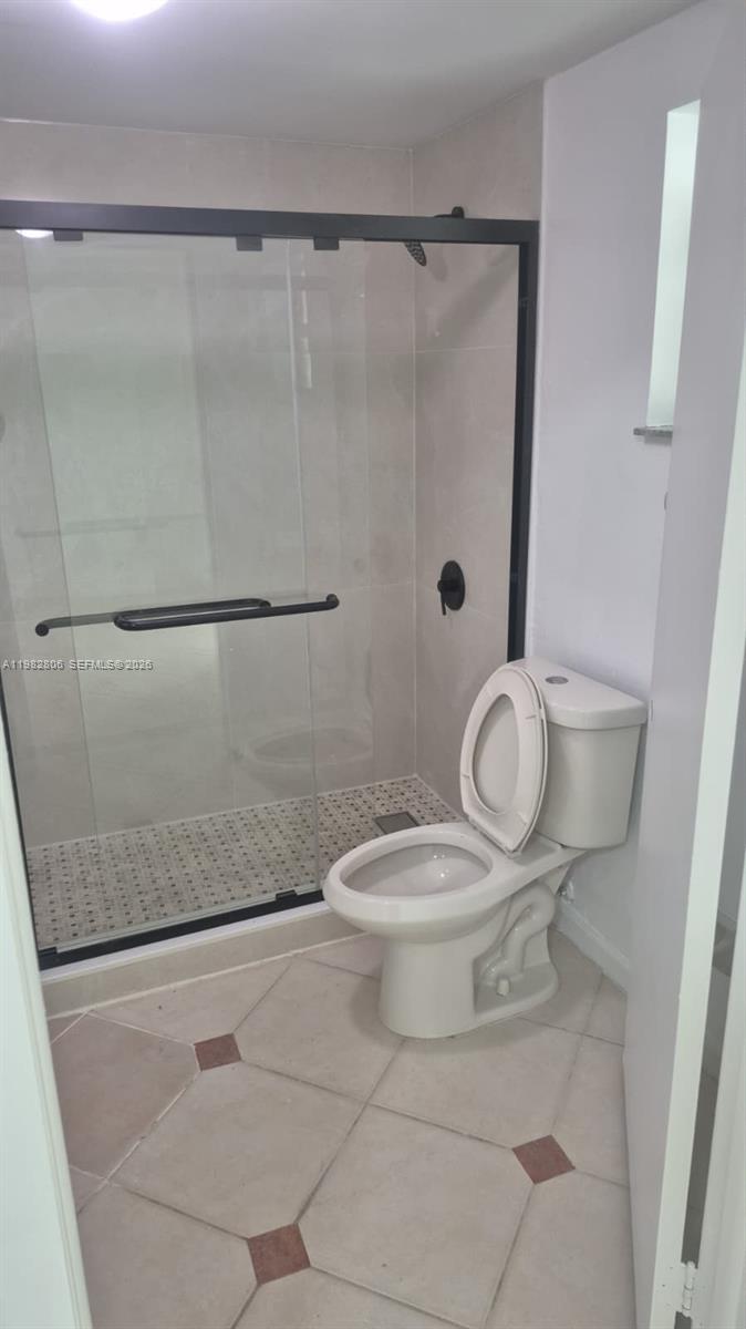 3355 West 68th Street, Unit 119 Hialeah, FL 33018 - Photo 10 of 11 a bathroom with a toilet and a shower