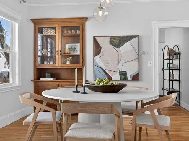 a view of a dining room with furniture and chandelier