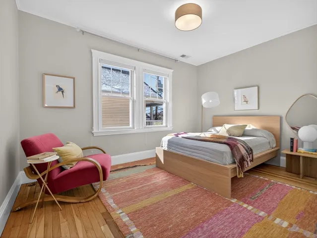 a bed room with a bed and a painting on the wall