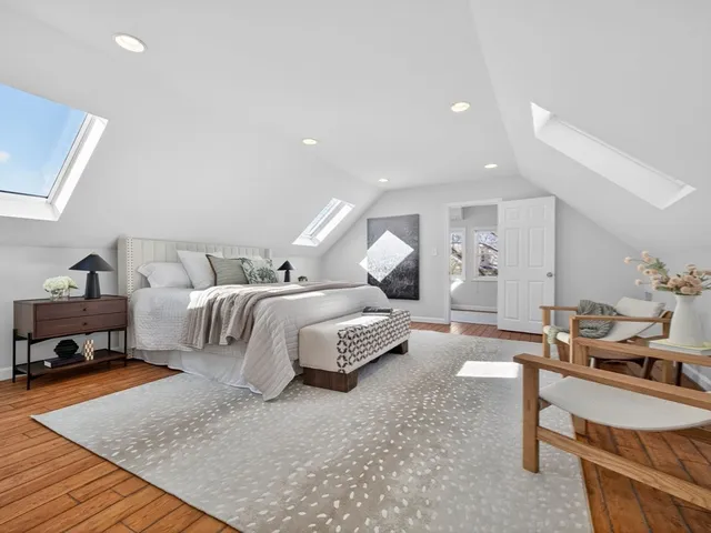 a bed room with a bed and a chair