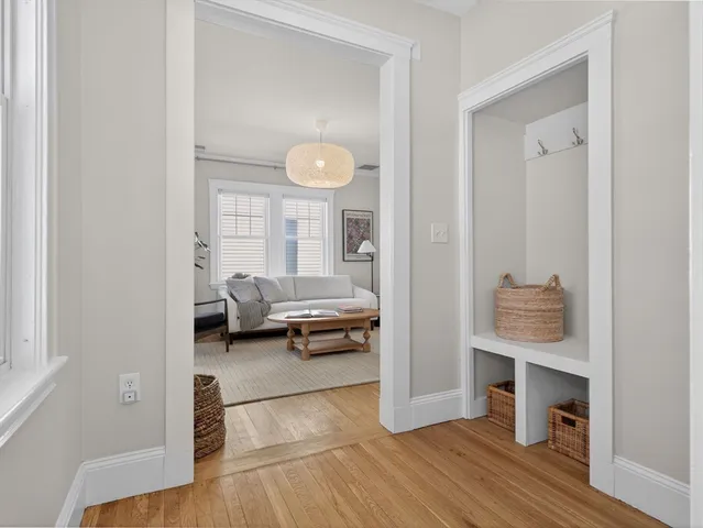 a view of living room with furniture and wooden floor