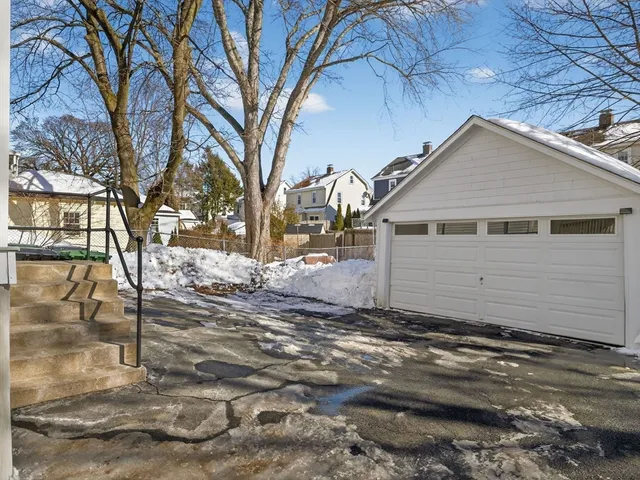 an aerial view of a house with a big yard and large trees