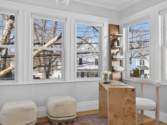 a living room with furniture a rug and a window