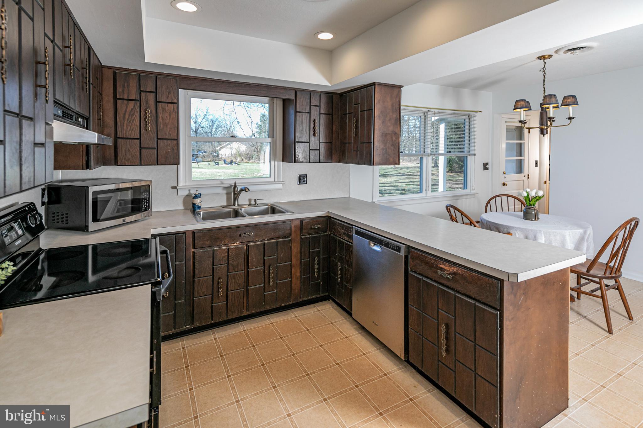 110 Johnstone Drive Pennington, NJ 08534 - Photo 12 of 31 a kitchen with stainless steel appliances a sink stove and cabinets