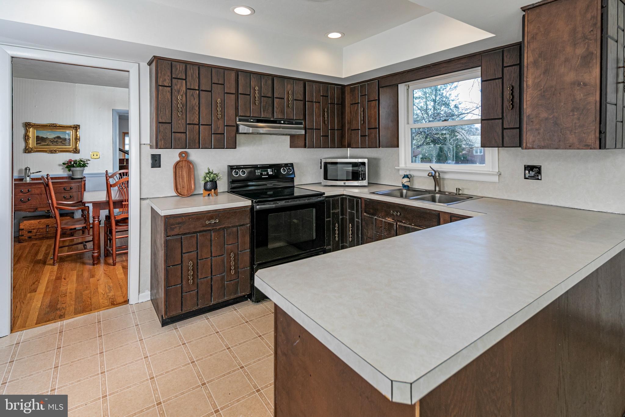 110 Johnstone Drive Pennington, NJ 08534 - Photo 14 of 31 a kitchen with kitchen island granite countertop a stove top oven a sink a counter top space and cabinets