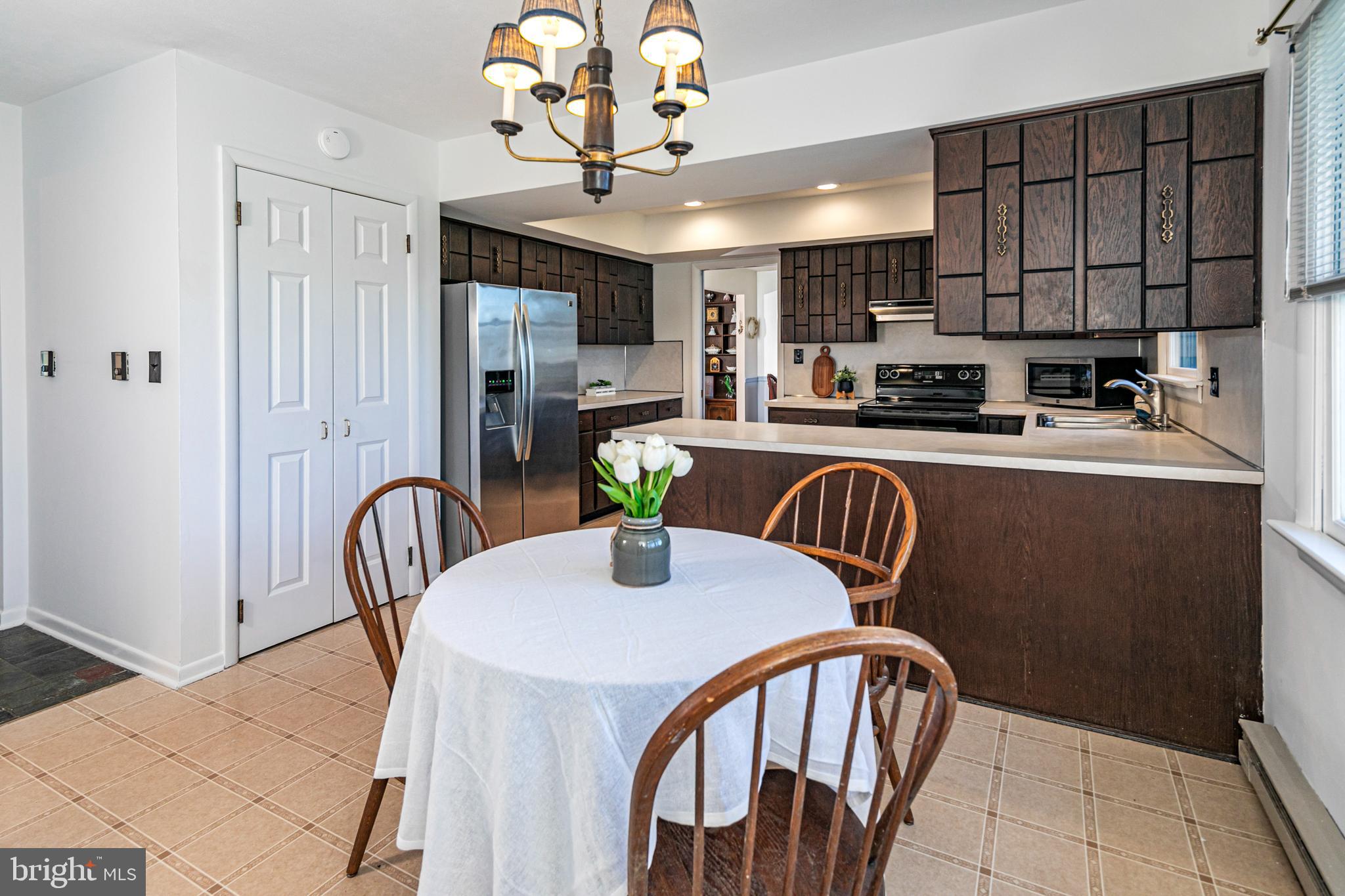 110 Johnstone Drive Pennington, NJ 08534 - Photo 17 of 31 a dining room with furniture and chandelier