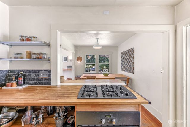 a kitchen with kitchen island a stove and a window