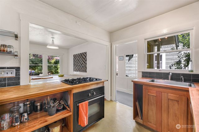 a kitchen with stainless steel appliances granite countertop stove top oven and cabinets