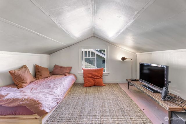 a bedroom with a large bed and a flat screen tv