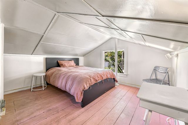 a spacious bedroom with a bed and a couch