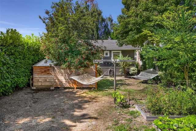 a view of a chair and table in backyard