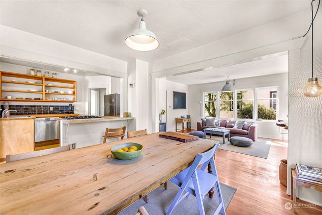 a view of a kitchen and dining room with wooden floor