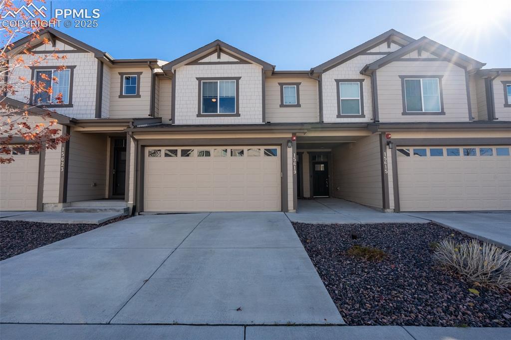 15619 Kitchener Way Monument, CO 80132 - Photo 1 of 40 a front view of a house with a yard and garage