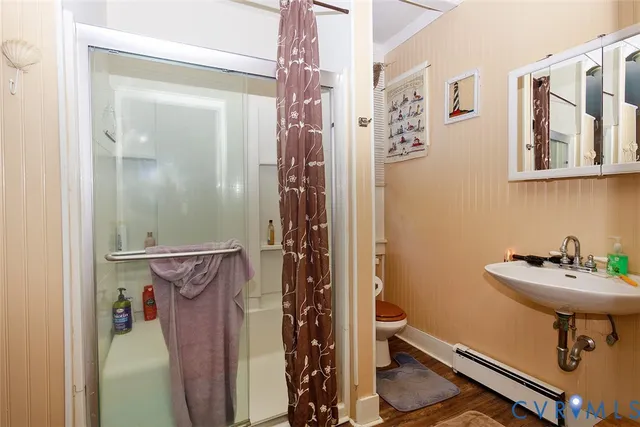 a bathroom with a sink toilet and shower