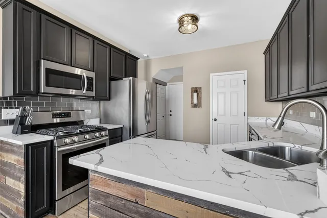a kitchen with a sink a stove and refrigerator