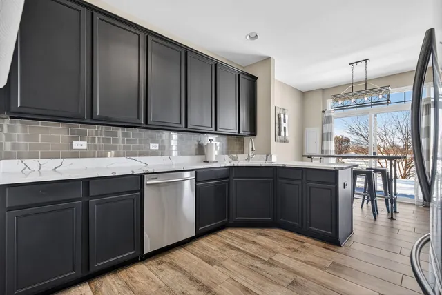 a kitchen with a sink cabinets and wooden floor