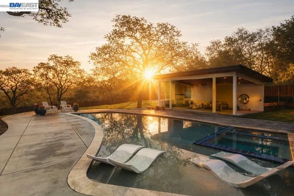 a view of a house with pool porch and sitting area