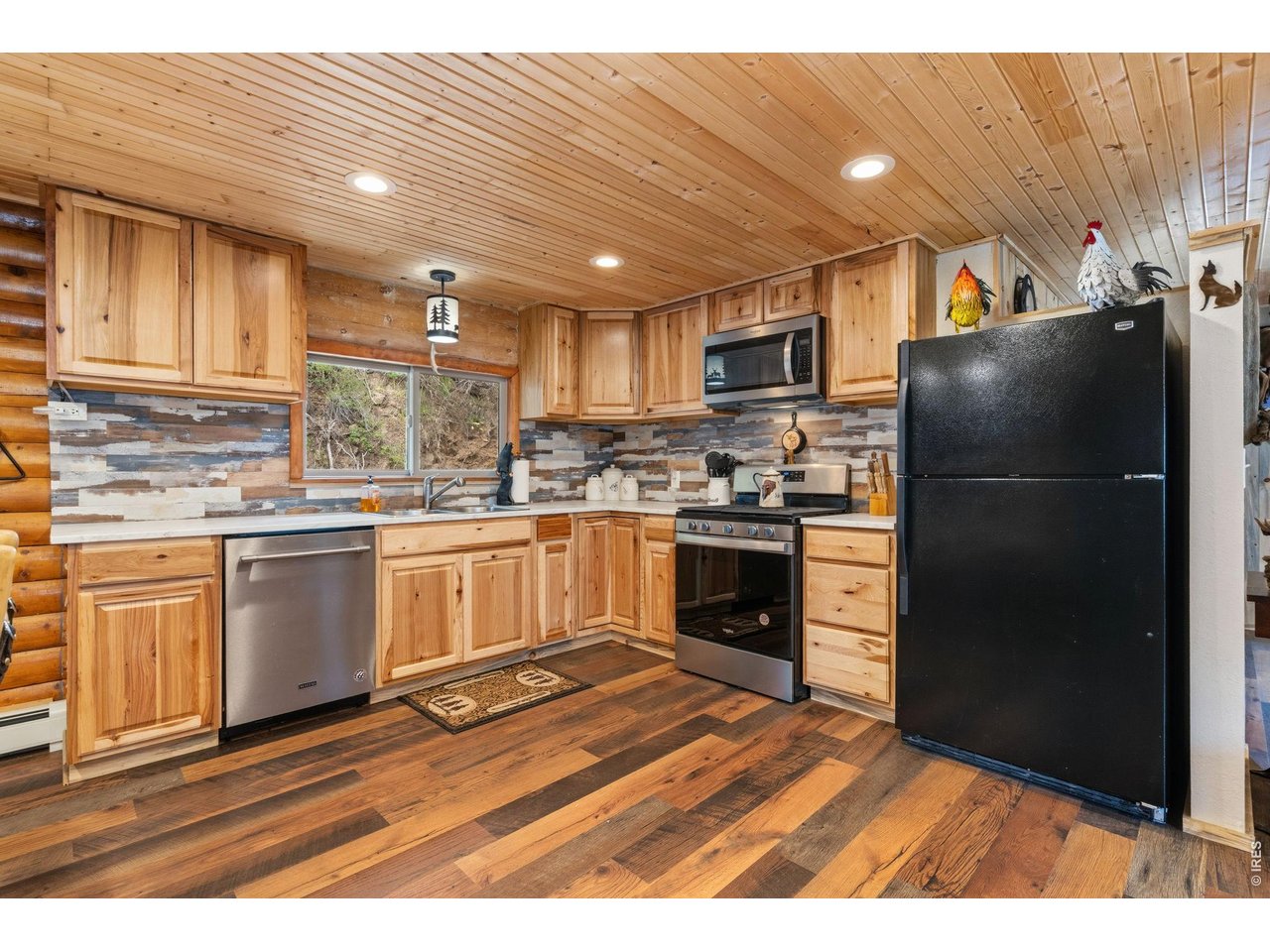 12743 Rist Canyon Road Bellvue, CO 80512 - Photo 13 of 49 a kitchen with granite countertop a refrigerator stove and oven