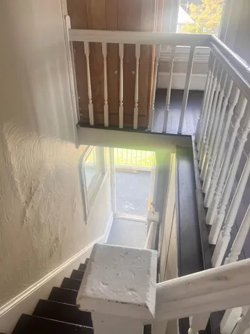 a view of a kitchen with wooden floor and a sink