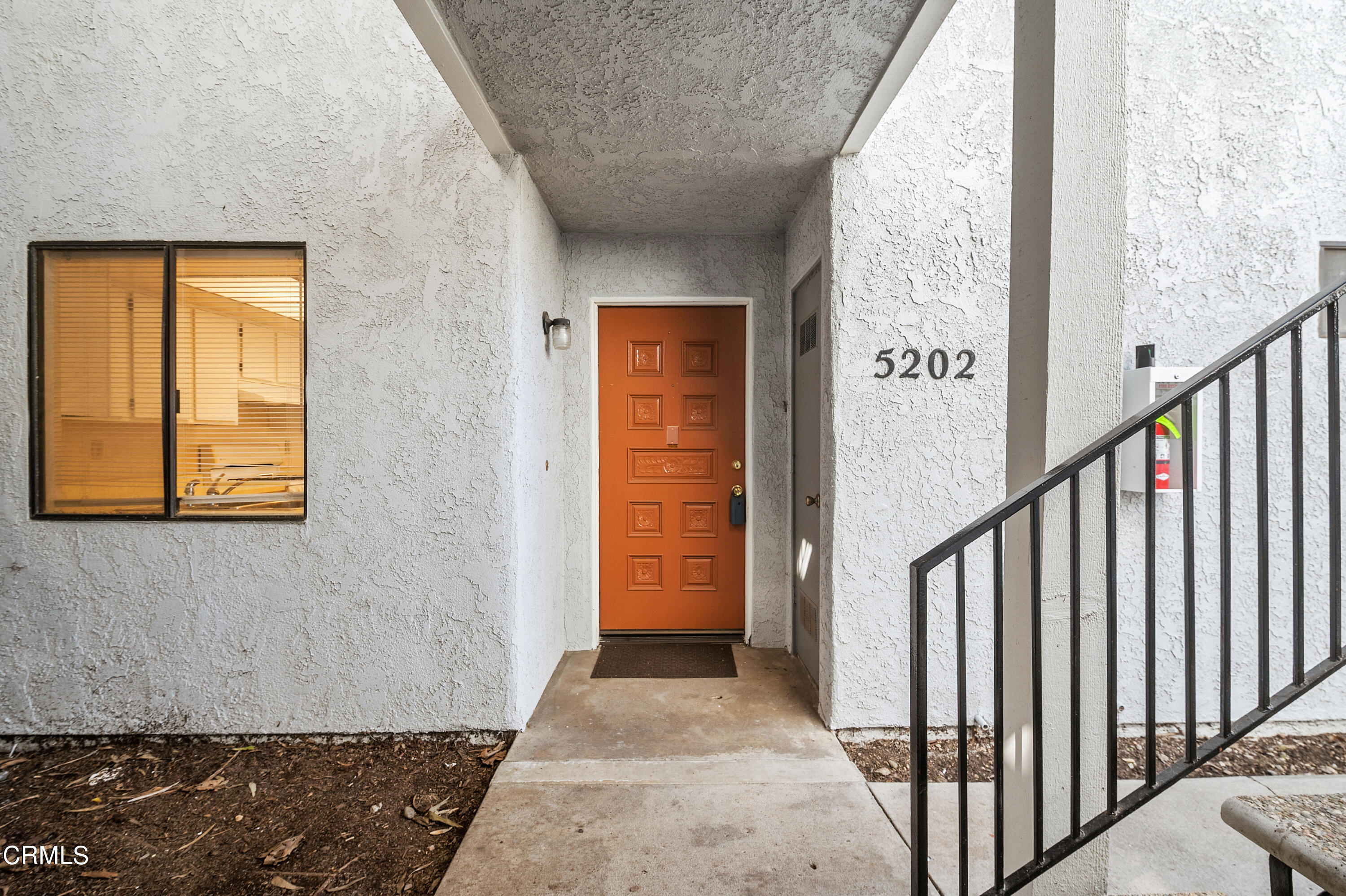 5202 Longfellow Way Oxnard, CA 93033 - Photo 2 of 21 a view of a hallway with wooden walls and windows