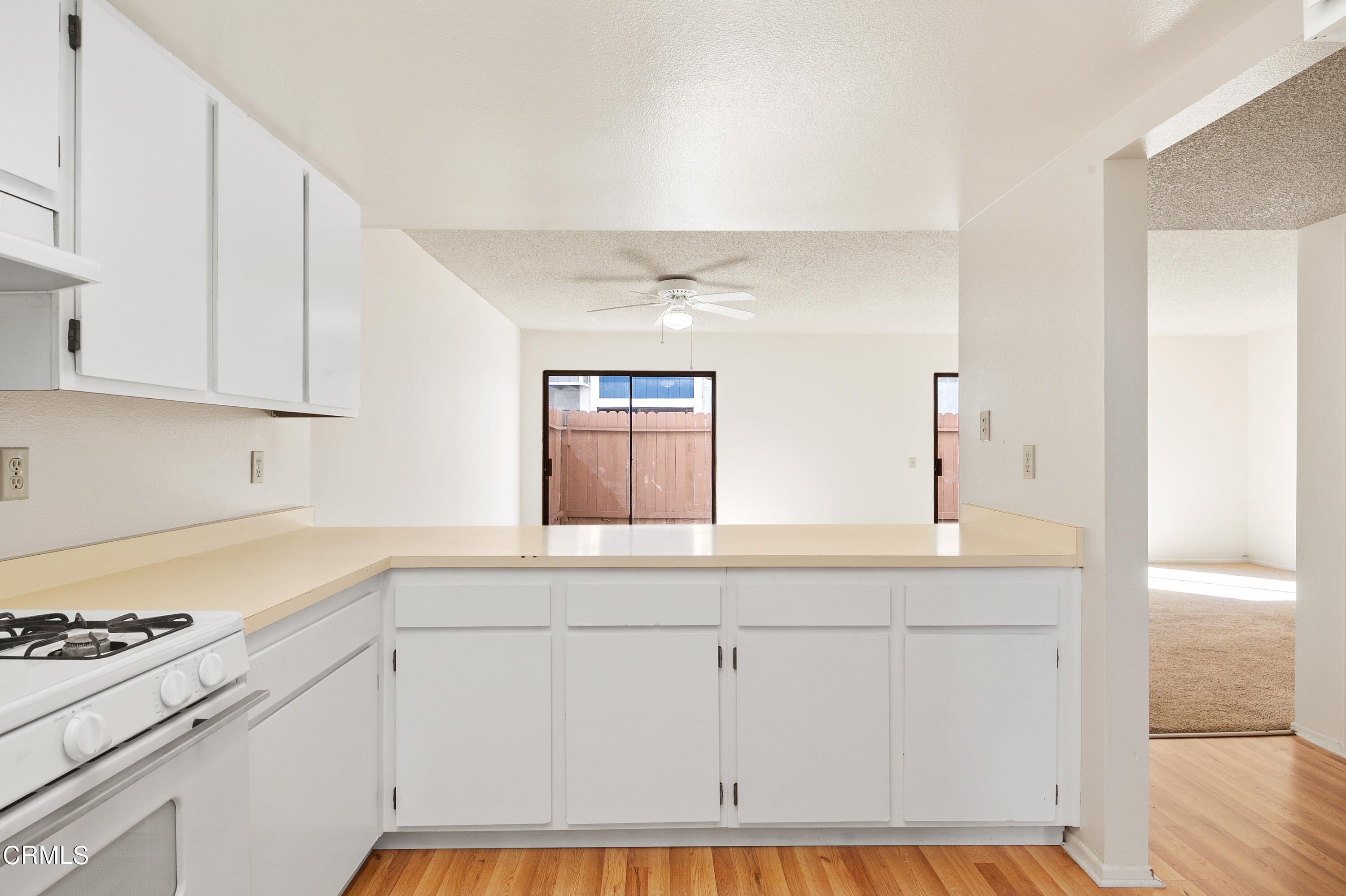5202 Longfellow Way Oxnard, CA 93033 - Photo 8 of 21 a kitchen with granite countertop white cabinets and white appliances