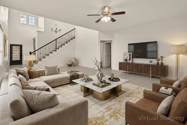 a living room with furniture a flat screen tv and kitchen view