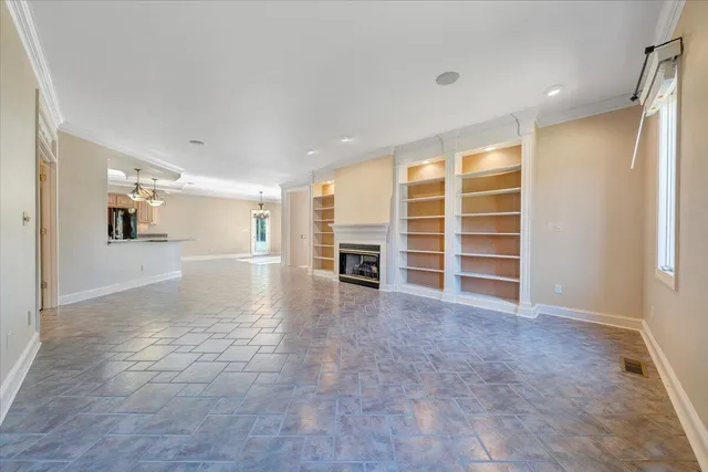 a kitchen with stainless steel appliances kitchen island granite countertop a stove a sink dishwasher and a refrigerator