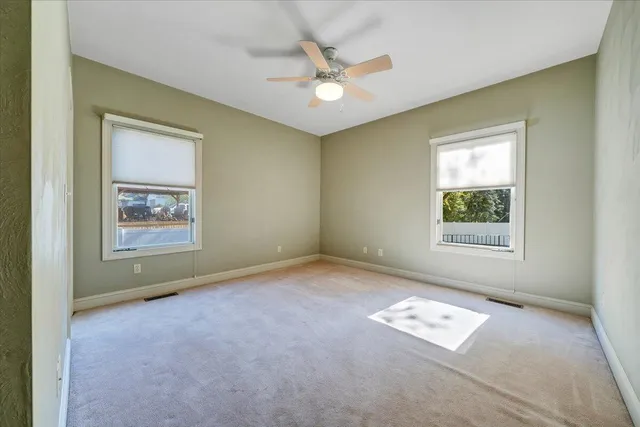 a view of walk in closet with empty racks