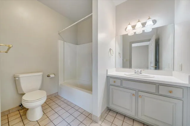 a spacious bathroom with a double vanity sink a mirror and a bathtub