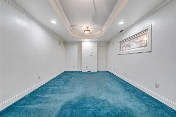 a front view of a house with a yard and lake view