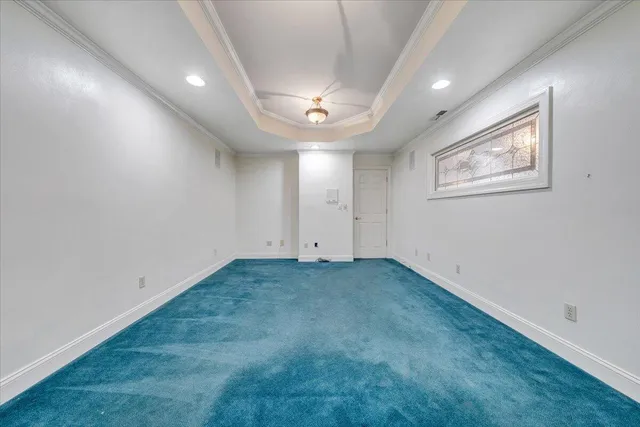 a front view of a house with a yard and lake view