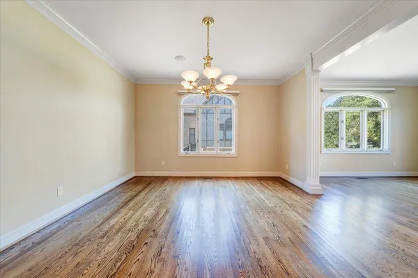 a view of an empty room with a fireplace and a window