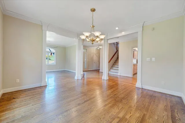 a view of an empty room with a fireplace and a window