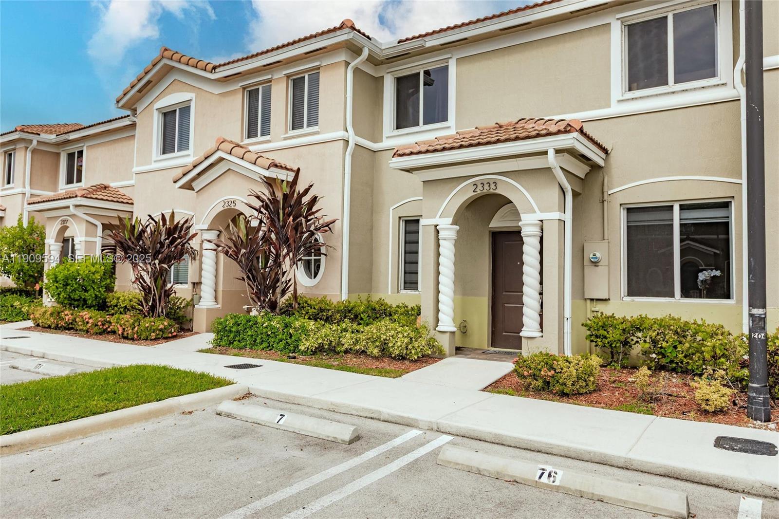 front view of a house with a garden