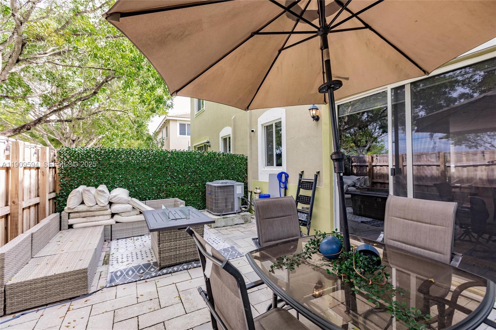 2333 Southeast 10th Street Homestead, FL 33035 - Photo 15 of 22 a view of a patio with table and chairs under an umbrella
