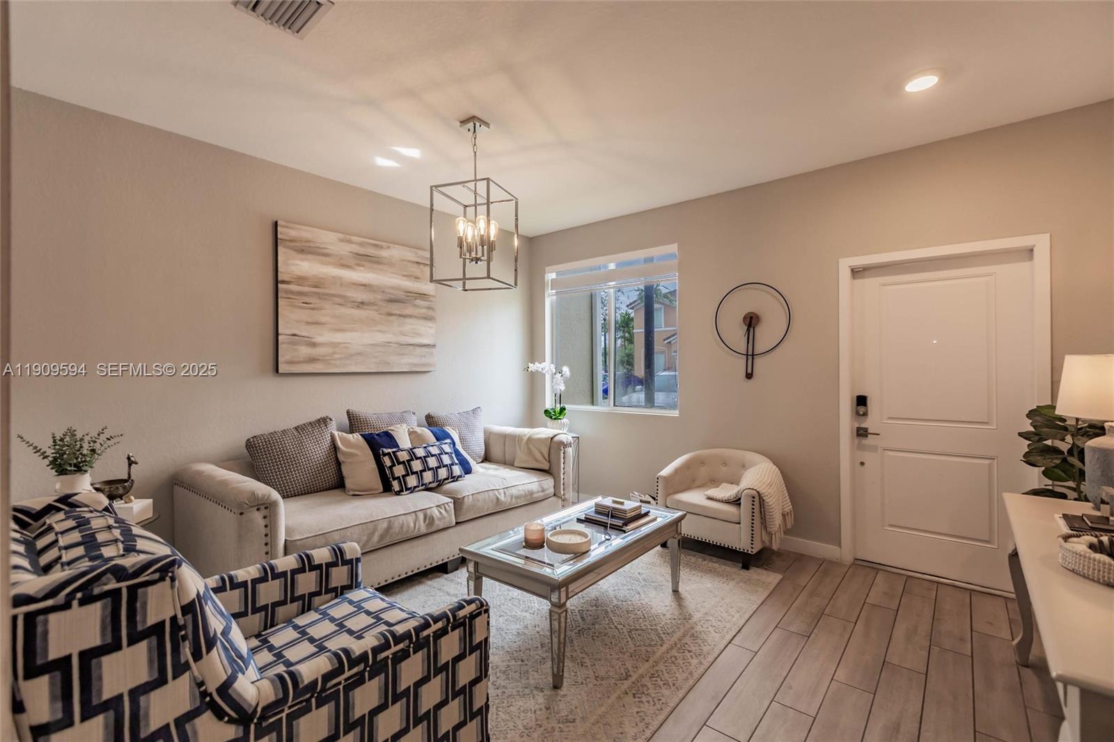 2333 Southeast 10th Street Homestead, FL 33035 - Photo 3 of 22 a living room with furniture and a chandelier