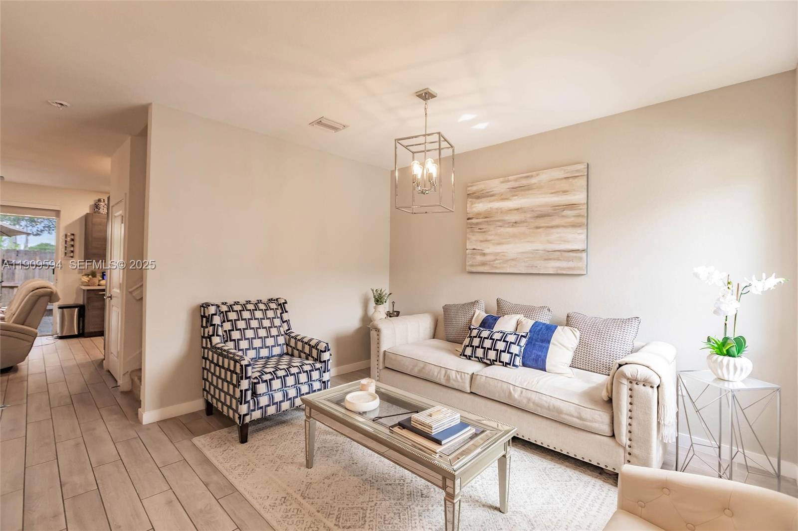 2333 Southeast 10th Street Homestead, FL 33035 - Photo 4 of 22 a living room with furniture and a chandelier