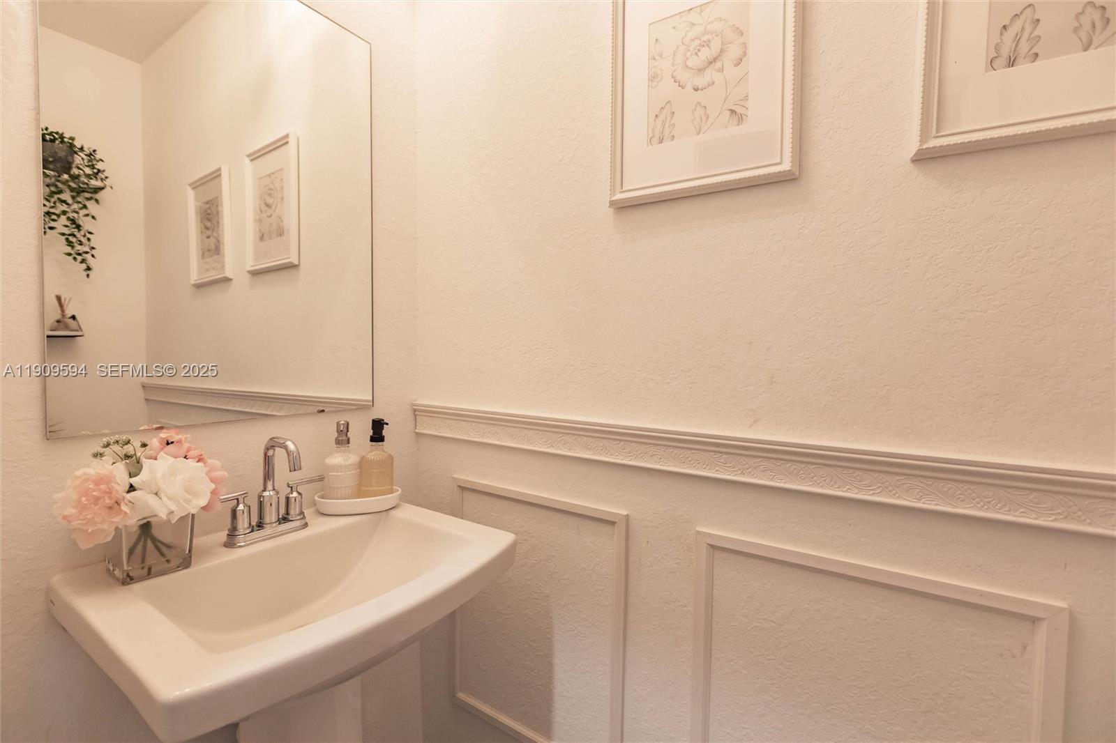 2333 Southeast 10th Street Homestead, FL 33035 - Photo 8 of 22 a bathroom with a sink and a mirror