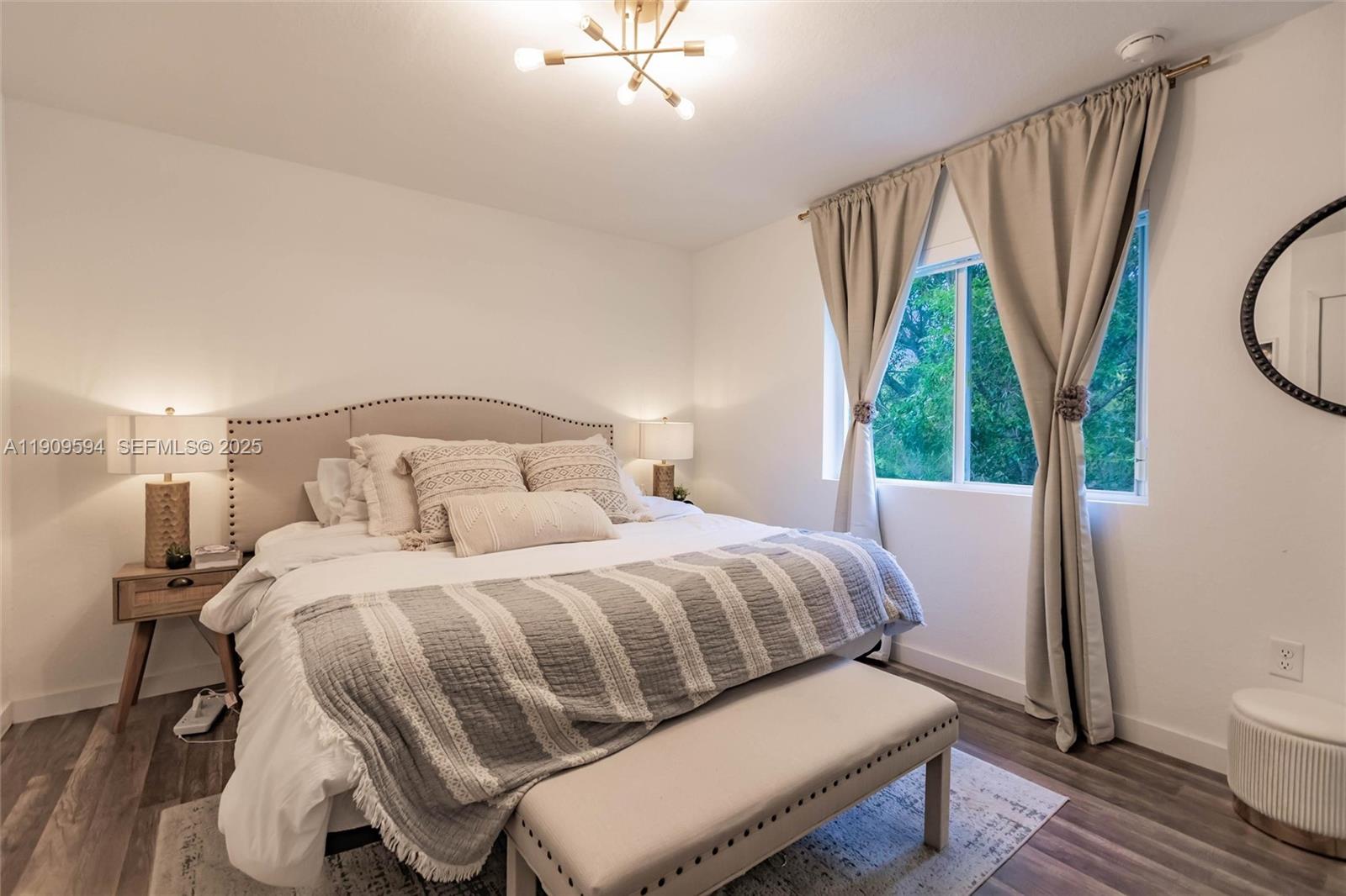 2333 Southeast 10th Street Homestead, FL 33035 - Photo 9 of 22 a bedroom with a bed a mirror and a large window