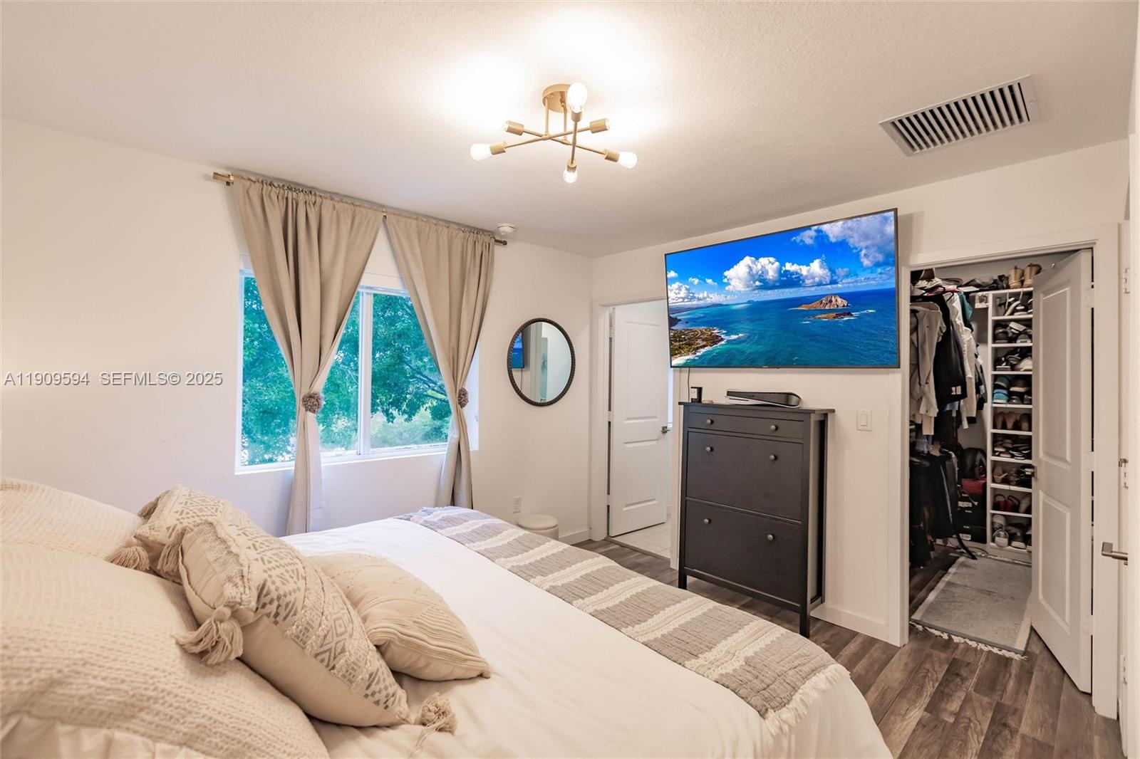 2333 Southeast 10th Street Homestead, FL 33035 - Photo 10 of 22 a bedroom with a bed and a flat tv screen on dresser