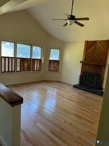 a living room with wooden floor and furniture
