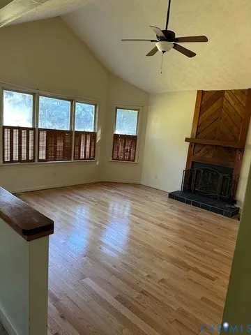 a living room with wooden floor and furniture