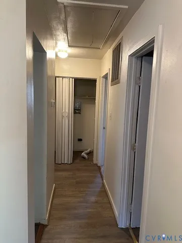 a view of a hallway with wooden floor