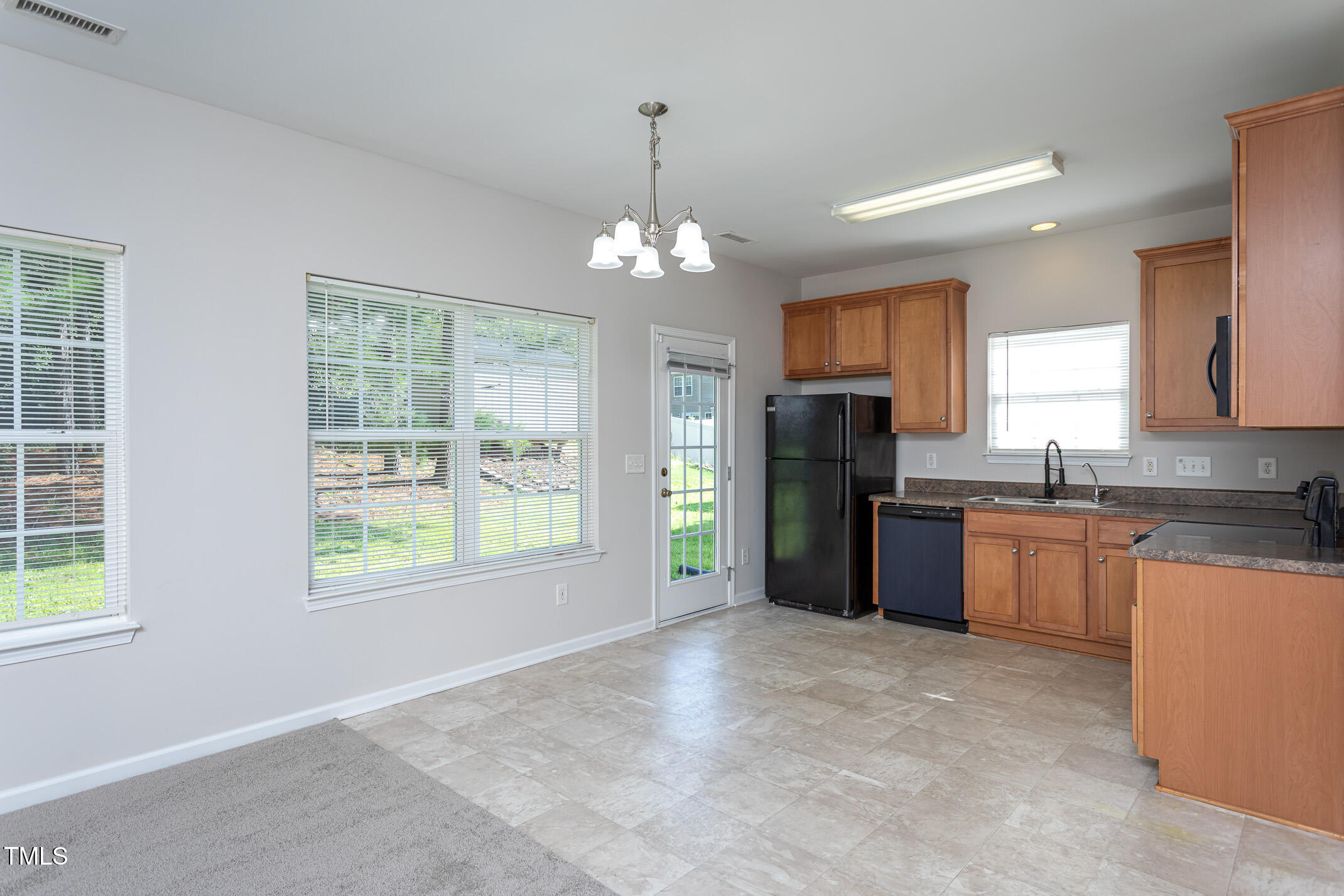 601 Weeping Willow Drive Durham, NC 27704 - Photo 13 of 36 a view of a kitchen with granite countertop stainless steel appliances sink and cabinets