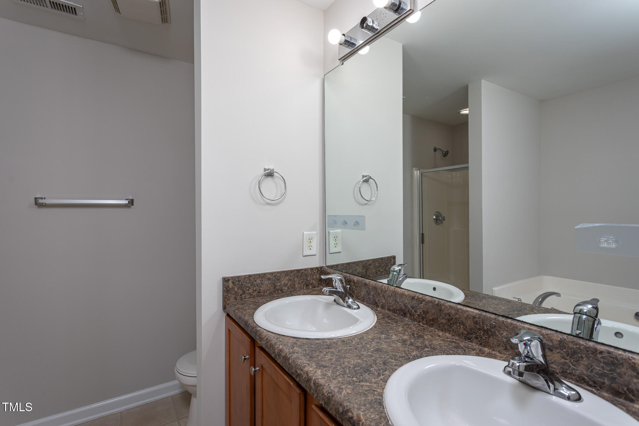 601 Weeping Willow Drive Durham, NC 27704 - Photo 15 of 36 a bathroom with a granite countertop sink and a mirror
