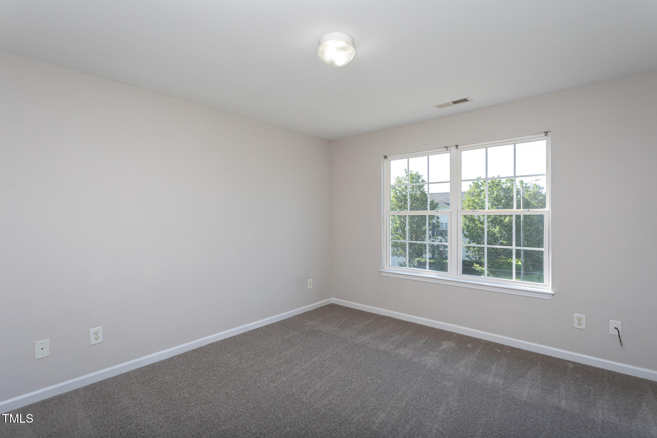 601 Weeping Willow Drive Durham, NC 27704 - Photo 17 of 36 an empty room with a window